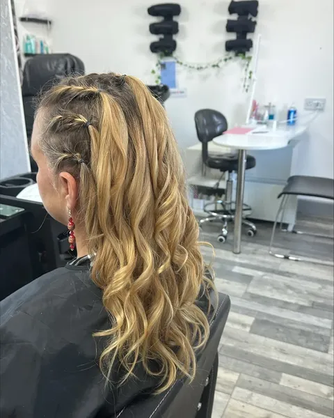 Braided and curled hair styled in the Tuition Extra salon