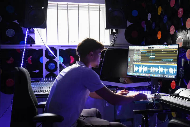 A student mixing a track in the music studio